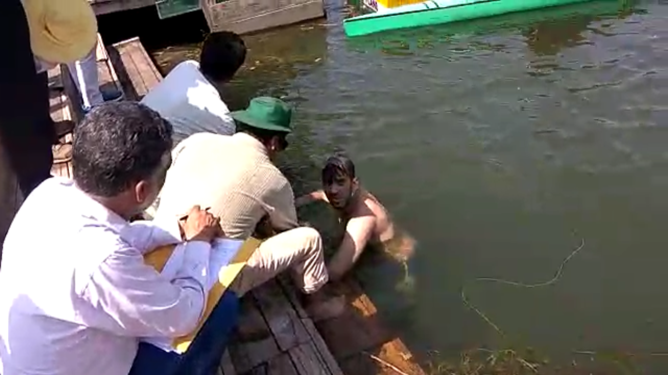 A student resting before coming out of the lake after completing Dal Re-Cross.